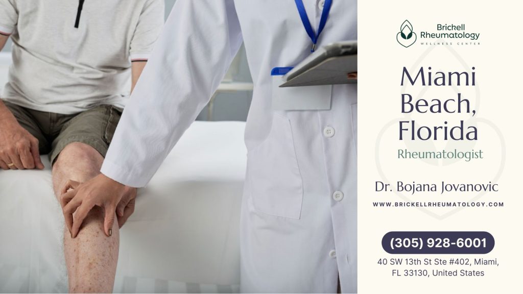 Miami Beach, FL 1 Miami Beach, FL A rheumatologist in a white coat evaluates a patient's knee at Brickell Rheumatology Wellness Center, providing dedicated care for joint conditions.
