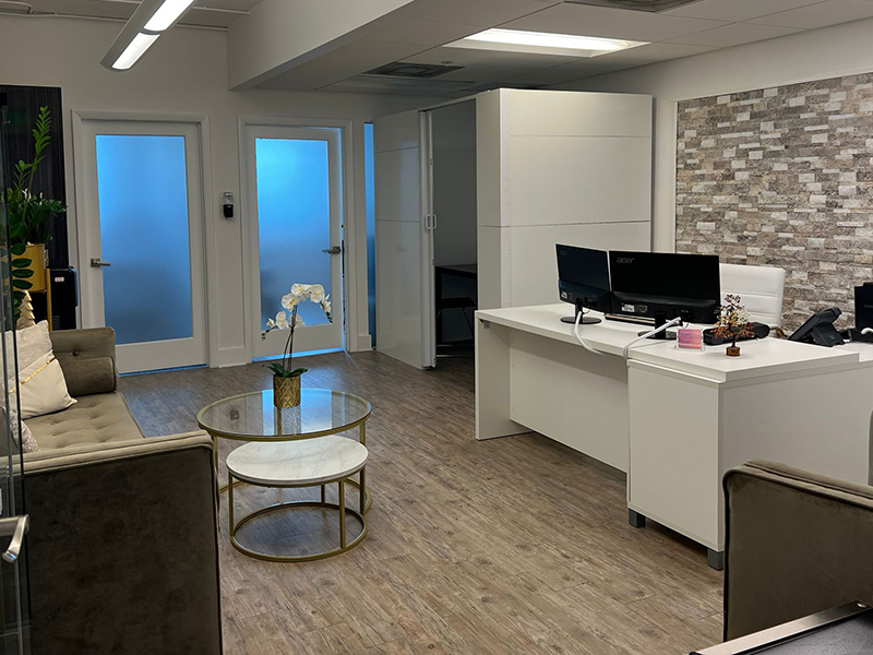 Contact 2 Contact Us A tidy office featuring a desk and a comfortable couch, creating a professional and inviting workspace.