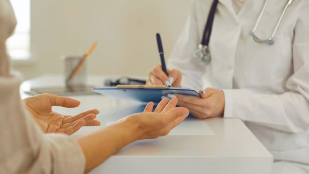 A doctor discusses treatment options with a patient in a functional medicine rheumatology setting.