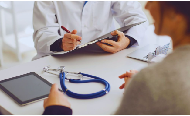 Functional Rheumatology: Why Early Intervention Matters 3 A functional medicine specialist reviewing wellness data with a patient during an early intervention consultation.
